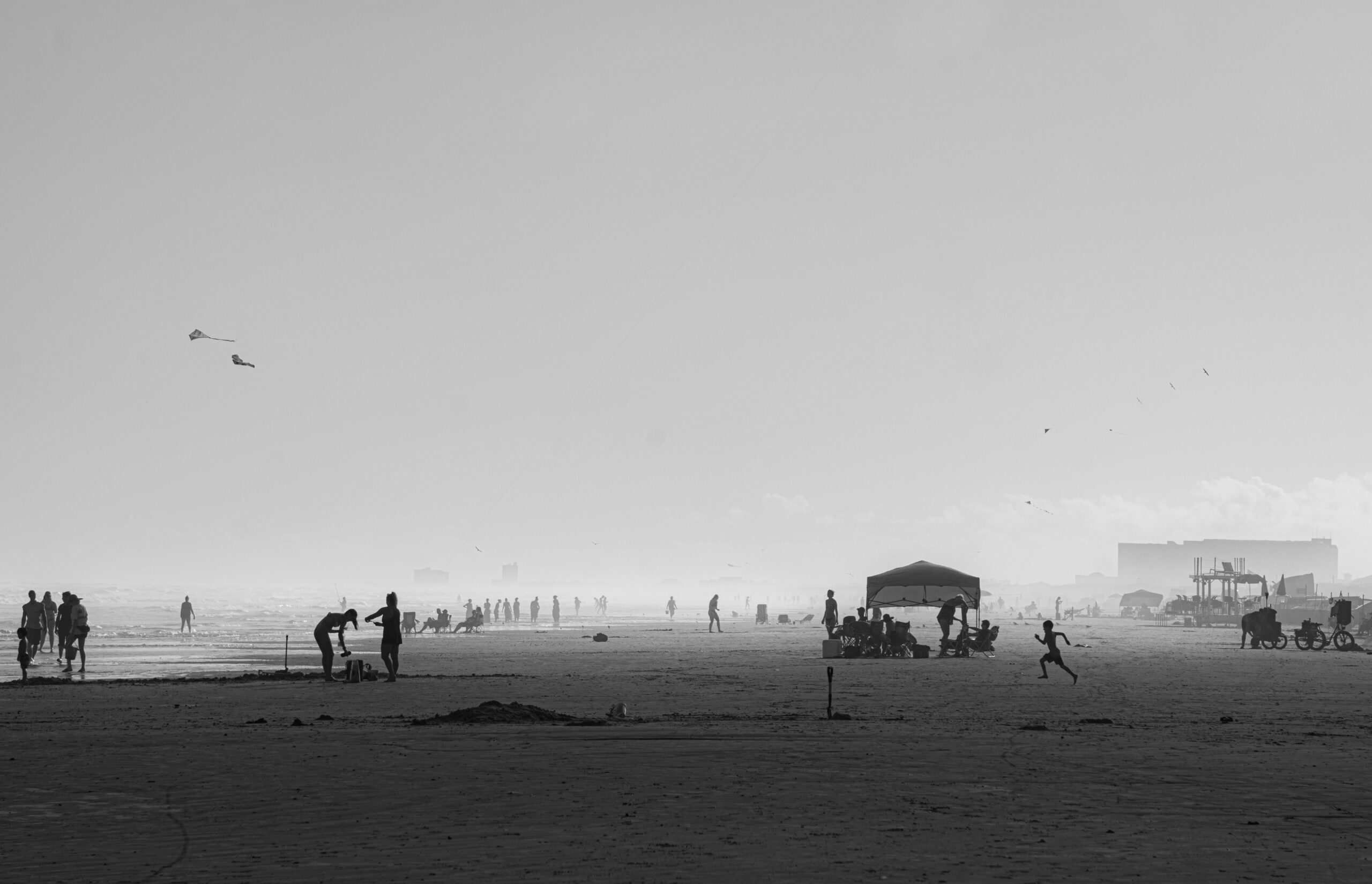 Black and white photo of people enjoying a beach in Corpus Christi, Texas.